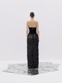 A Black Strapless Gown with a High Slit and Textured Skirt
