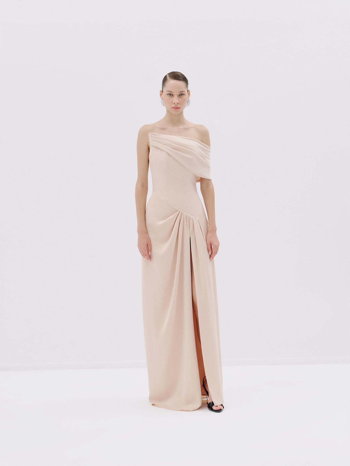 One-shoulder draped gown.