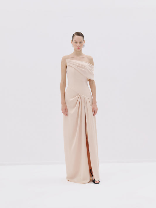 One-shoulder draped gown.