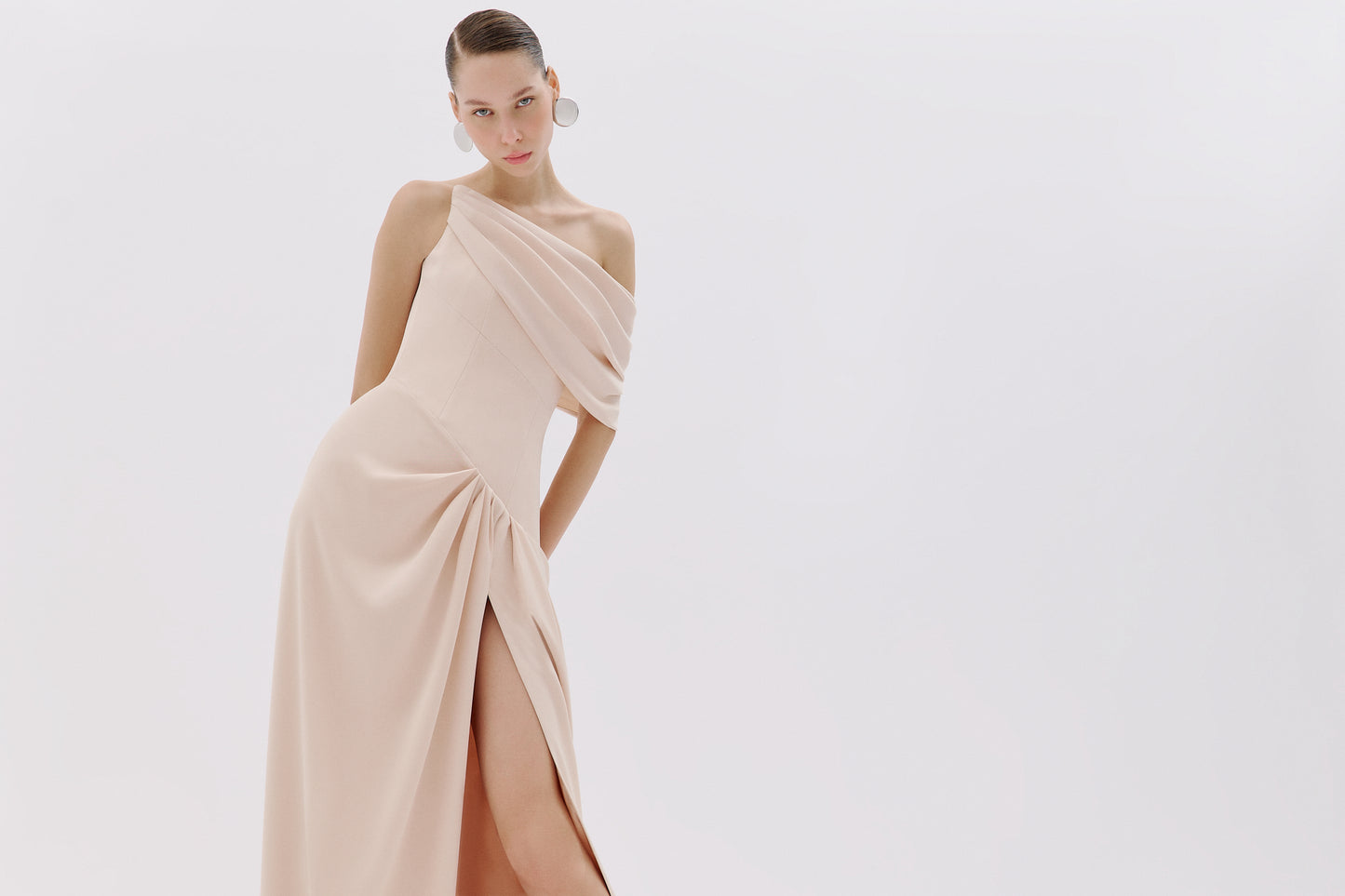 One-shoulder draped gown.