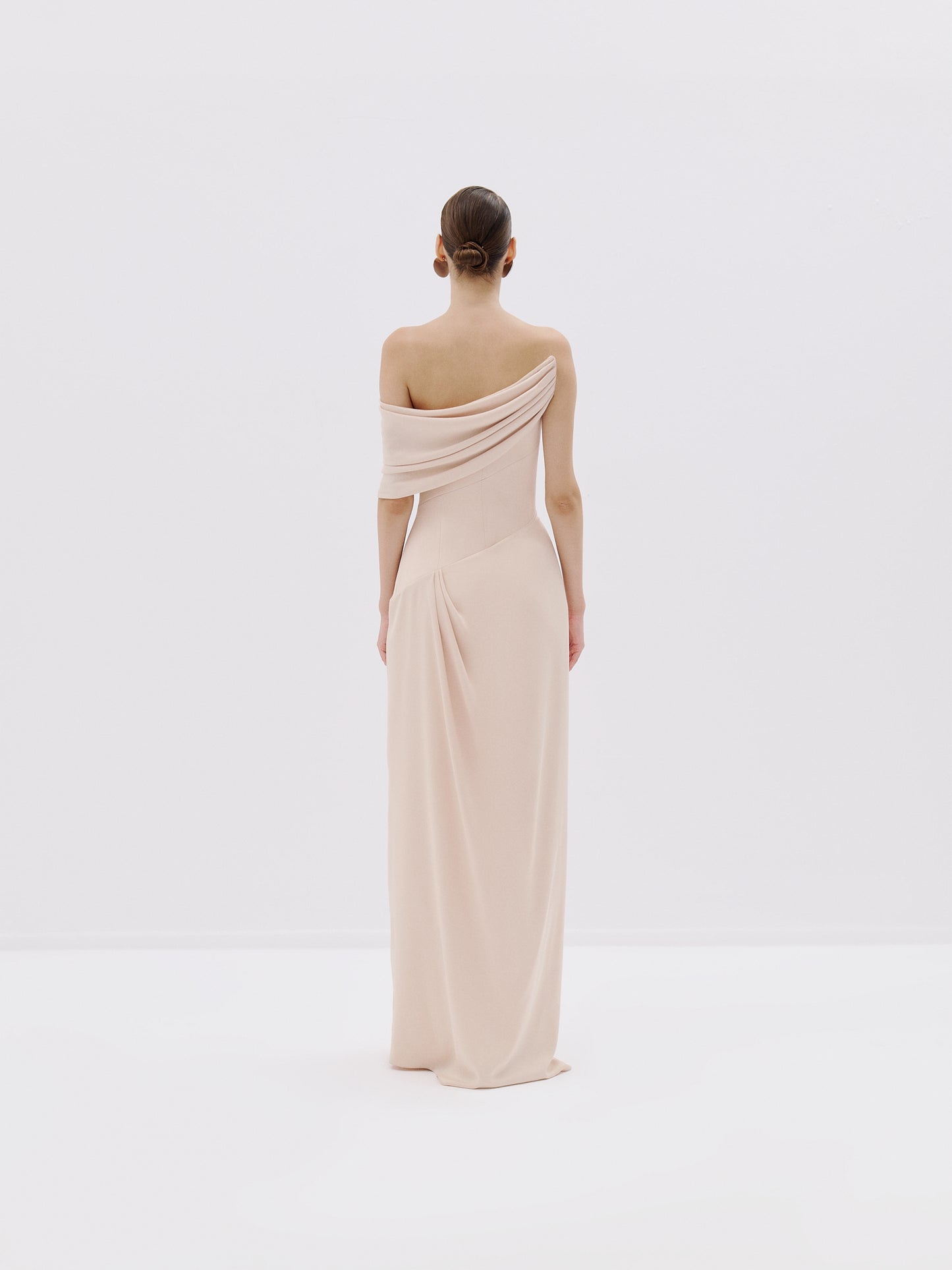 One-shoulder draped gown.