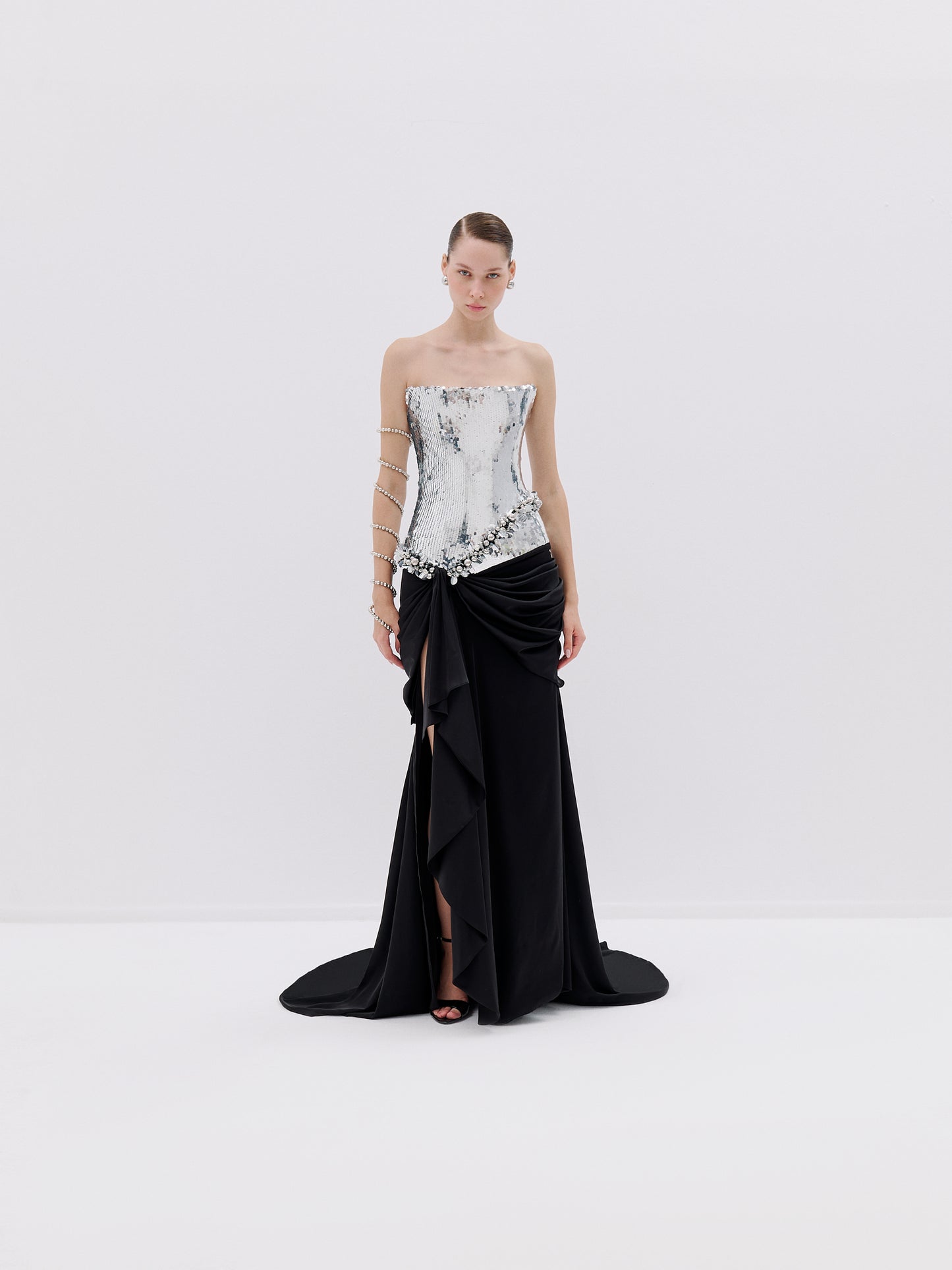 Strapless silver bodice gown with black draped skirt.