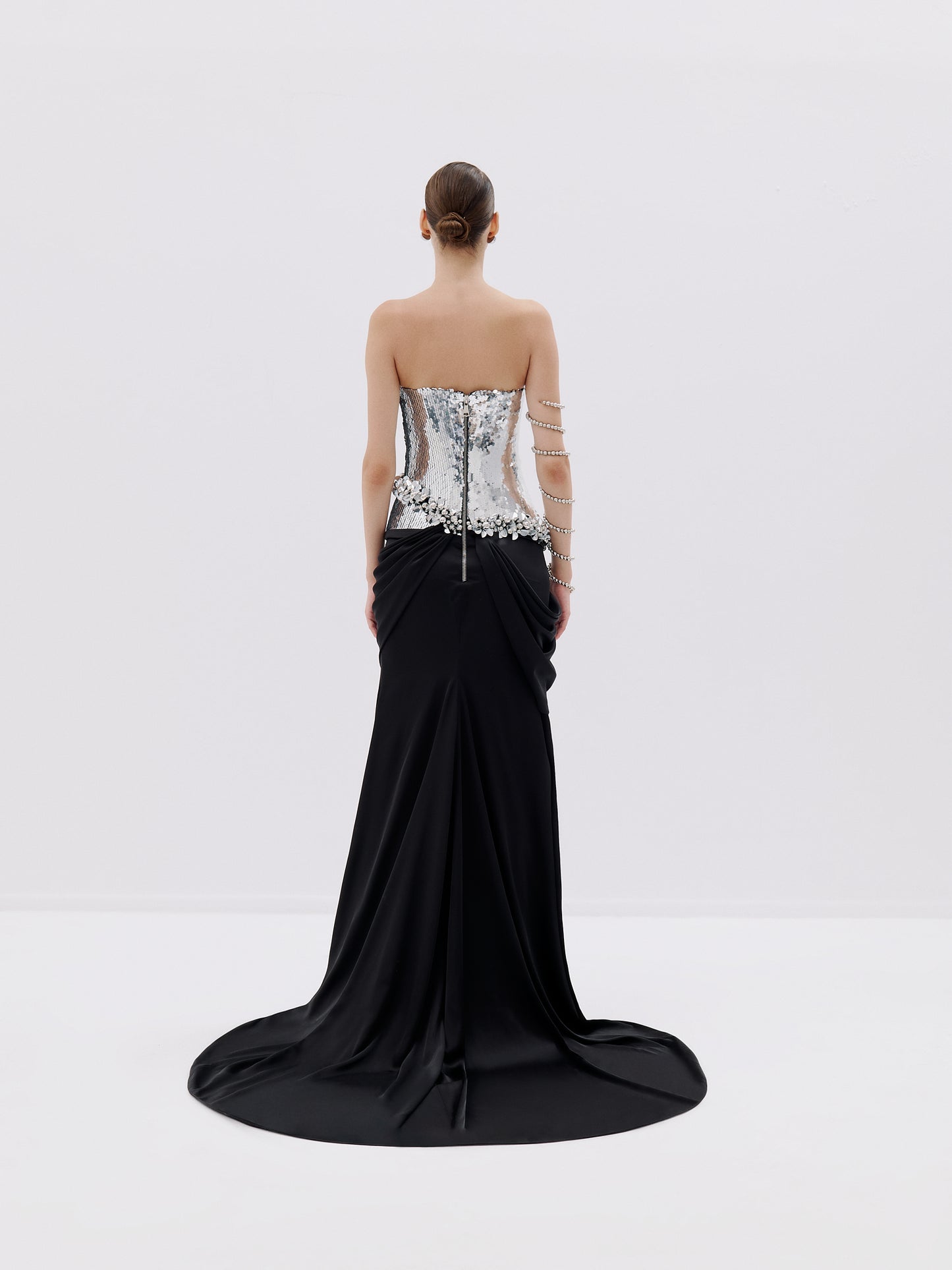 Strapless silver bodice gown with black draped skirt.