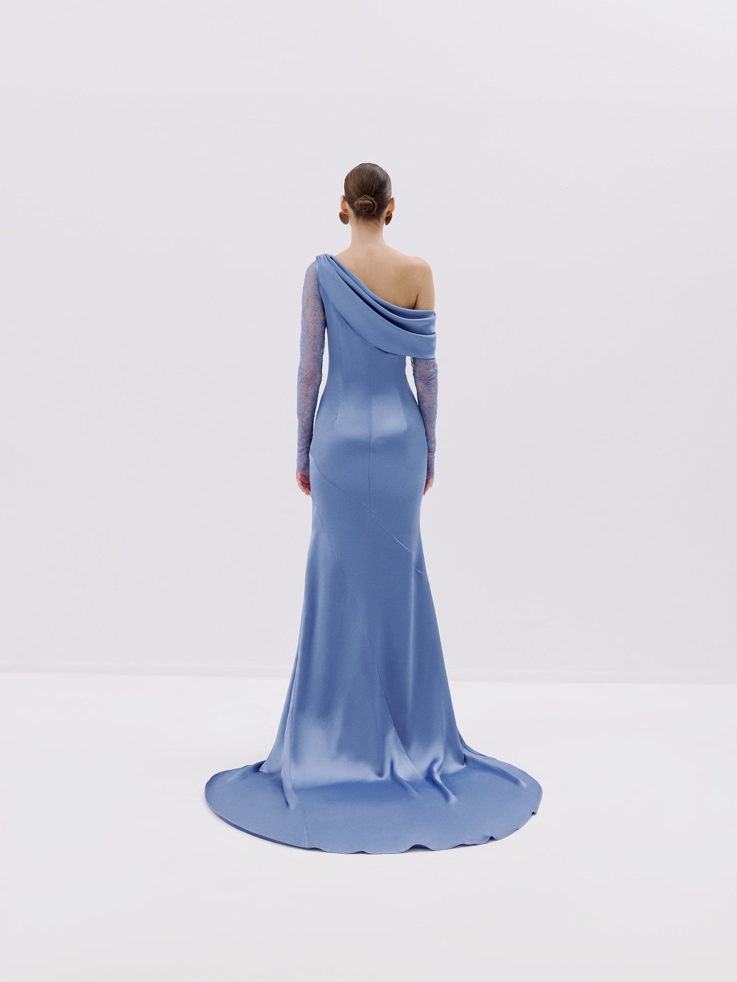 One-shoulder gown with lace sleeve and draped neckline